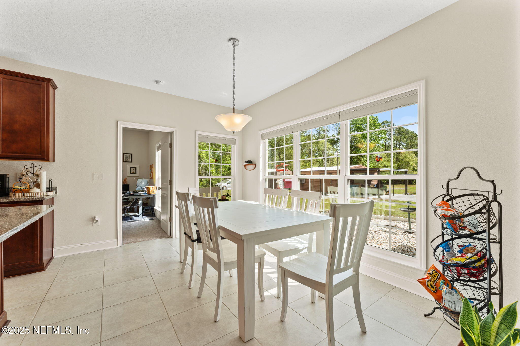 12869 Boney Road Jacksonville, FL 32226 - Photo 20 of 62 a dining room with furniture a chandelier and a rug