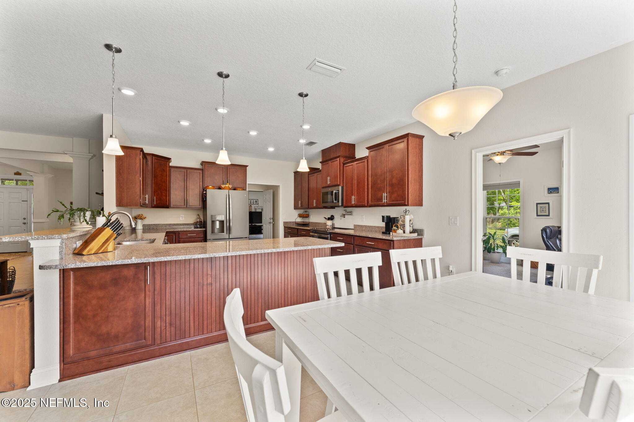 12869 Boney Road Jacksonville, FL 32226 - Photo 22 of 62 a large kitchen with lots of counter space dining table and chairs