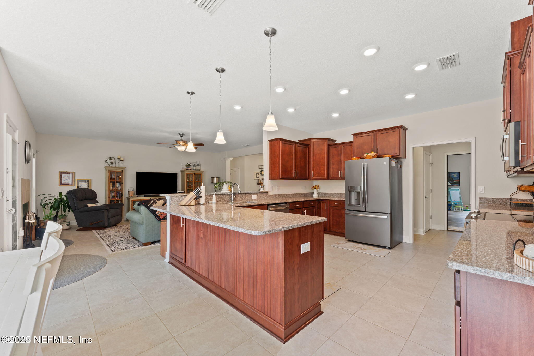 12869 Boney Road Jacksonville, FL 32226 - Photo 26 of 62 a kitchen with stainless steel appliances kitchen island granite countertop a stove and a refrigerator