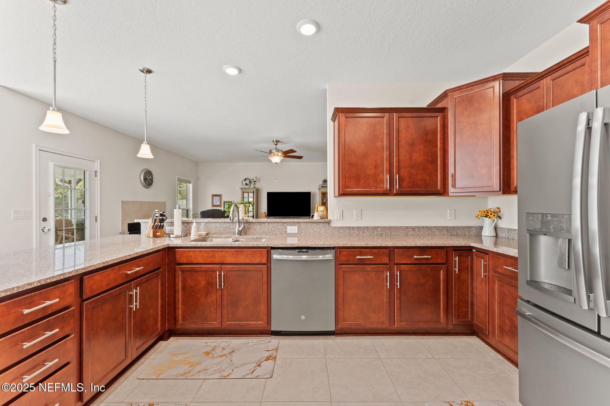 12869 Boney Road Jacksonville, FL 32226 - Photo 27 of 62 a kitchen with stainless steel appliances granite countertop a sink and dishwasher a refrigerator with wooden cabinets