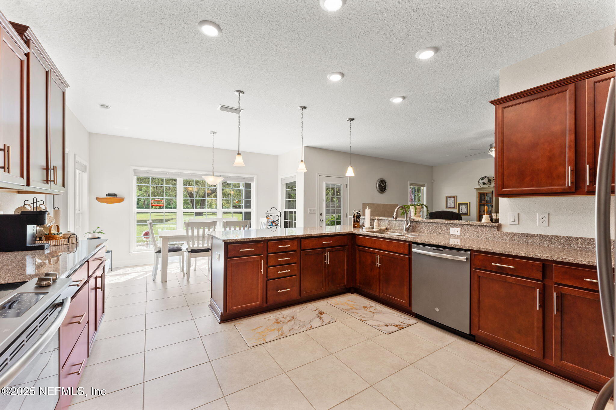 12869 Boney Road Jacksonville, FL 32226 - Photo 28 of 62 a large kitchen with stainless steel appliances granite countertop a stove sink and cabinets