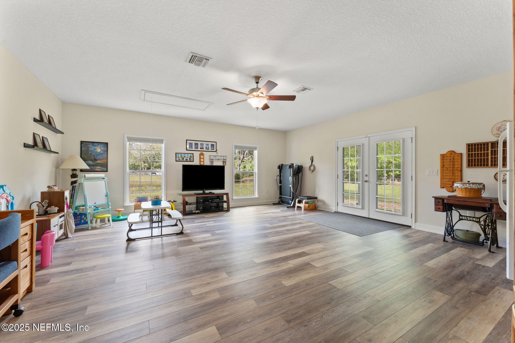 12869 Boney Road Jacksonville, FL 32226 - Photo 30 of 62 a living room with furniture and a flat screen tv