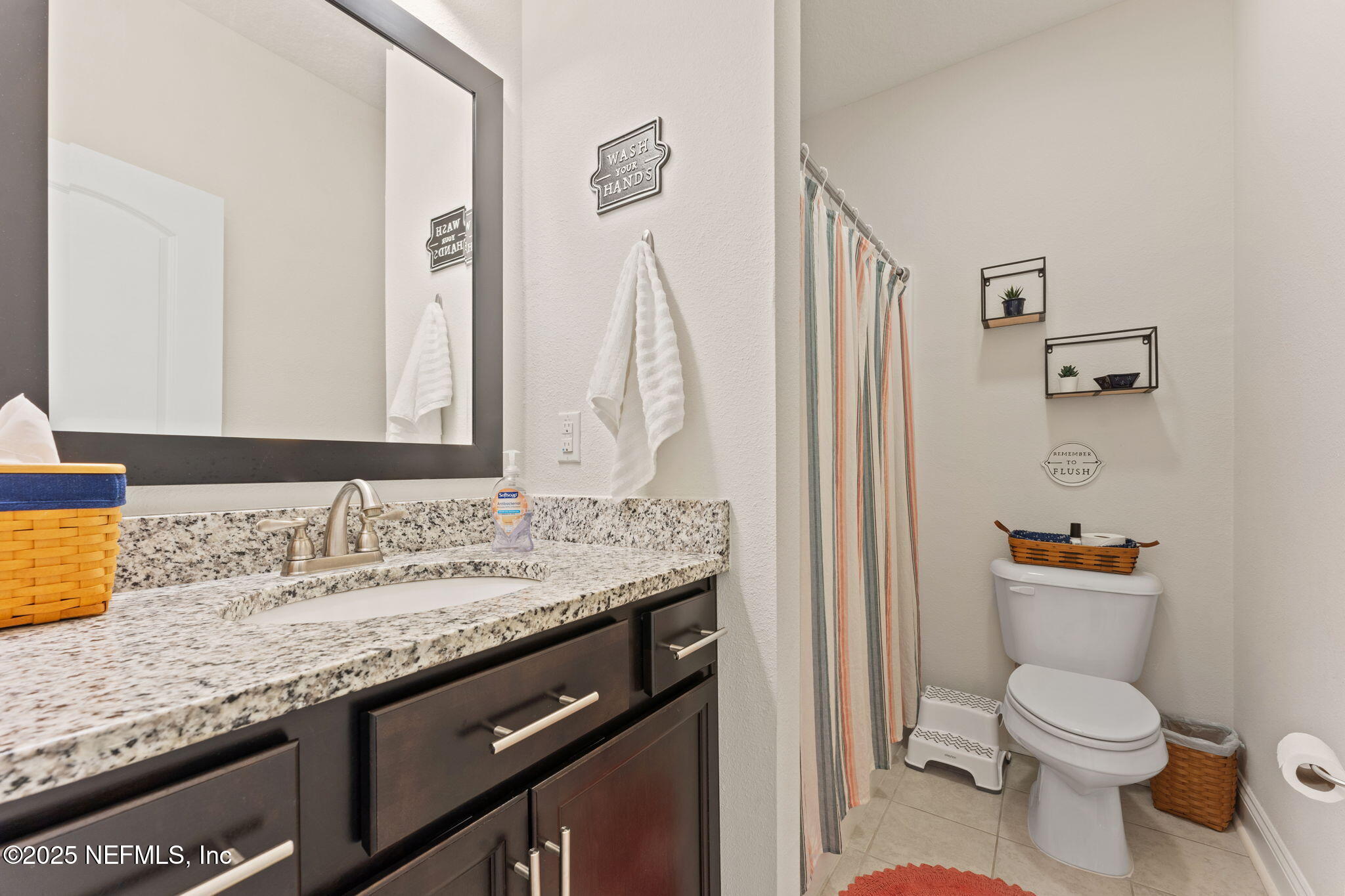 12869 Boney Road Jacksonville, FL 32226 - Photo 34 of 62 a bathroom with a granite countertop sink a toilet and a mirror
