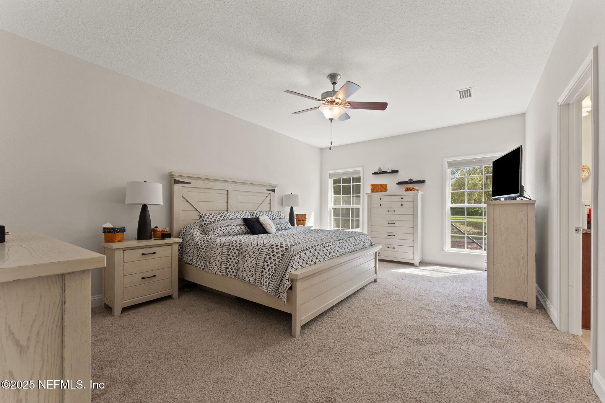 12869 Boney Road Jacksonville, FL 32226 - Photo 35 of 62 a spacious bedroom with a bed and a flat screen tv