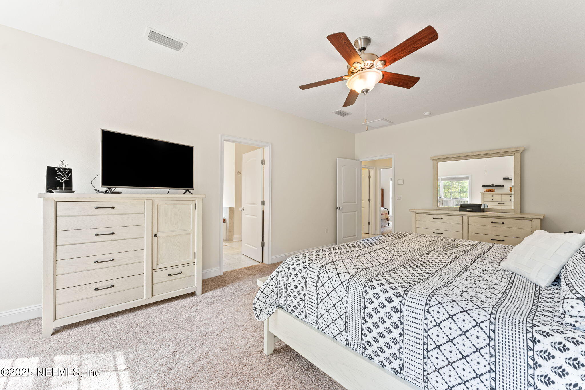 12869 Boney Road Jacksonville, FL 32226 - Photo 36 of 62 a bedroom with a bed and a flat screen tv
