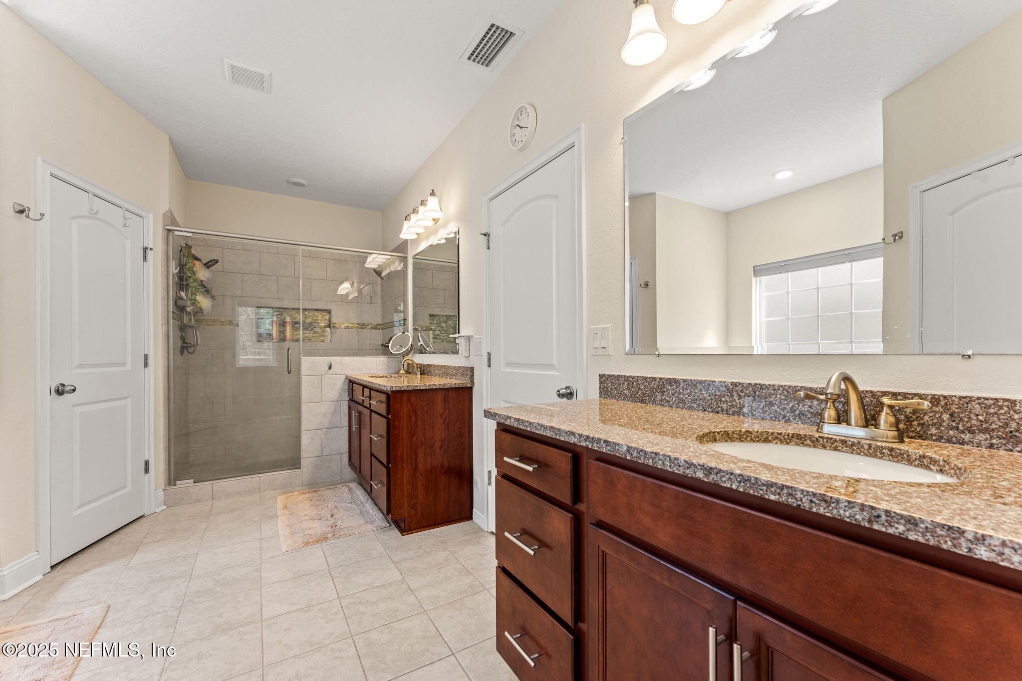 12869 Boney Road Jacksonville, FL 32226 - Photo 37 of 62 a spacious bathroom with a granite countertop sink mirror and a shower