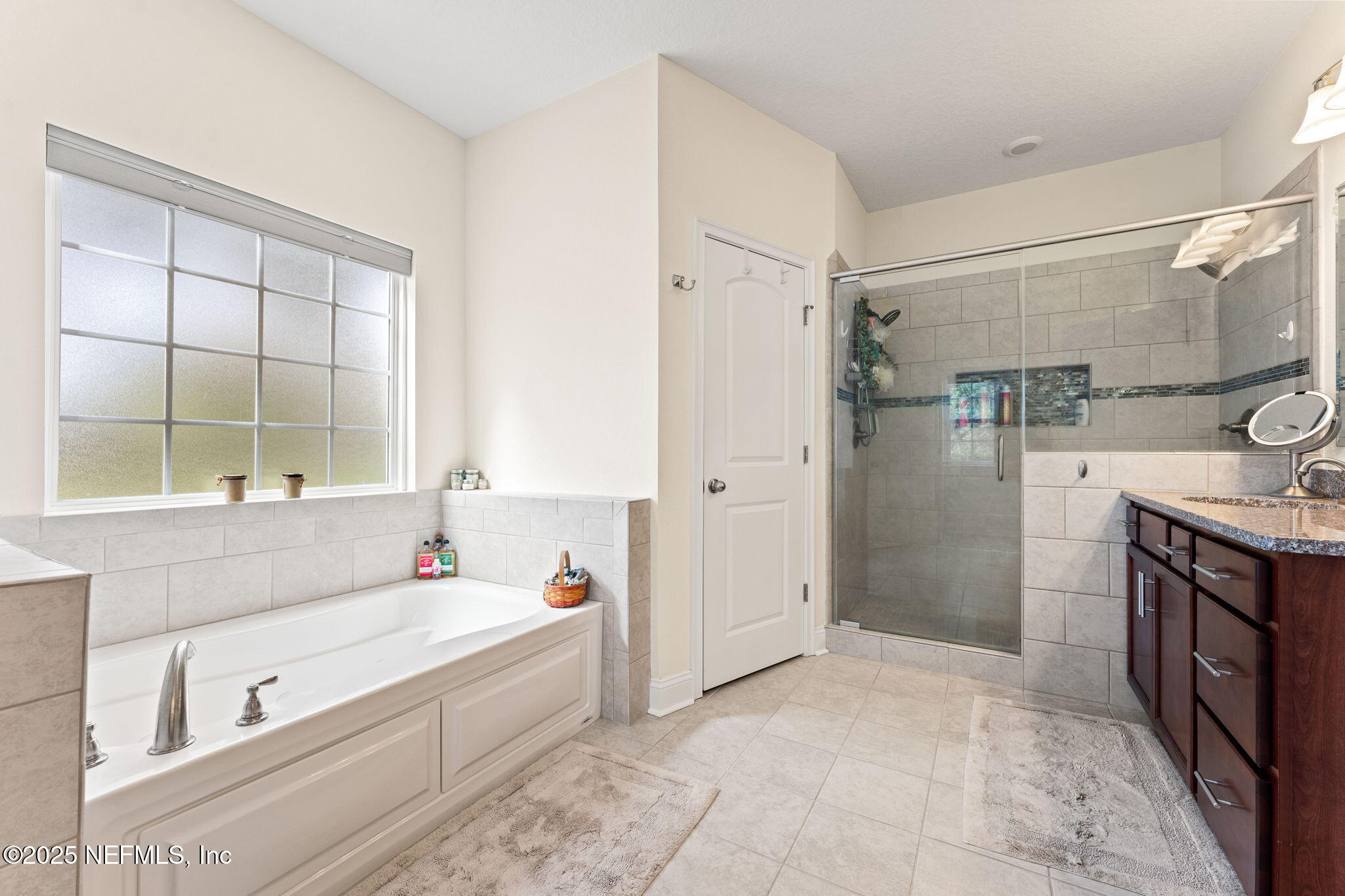 12869 Boney Road Jacksonville, FL 32226 - Photo 38 of 62 a spacious bathroom with a tub sink shower and mirror