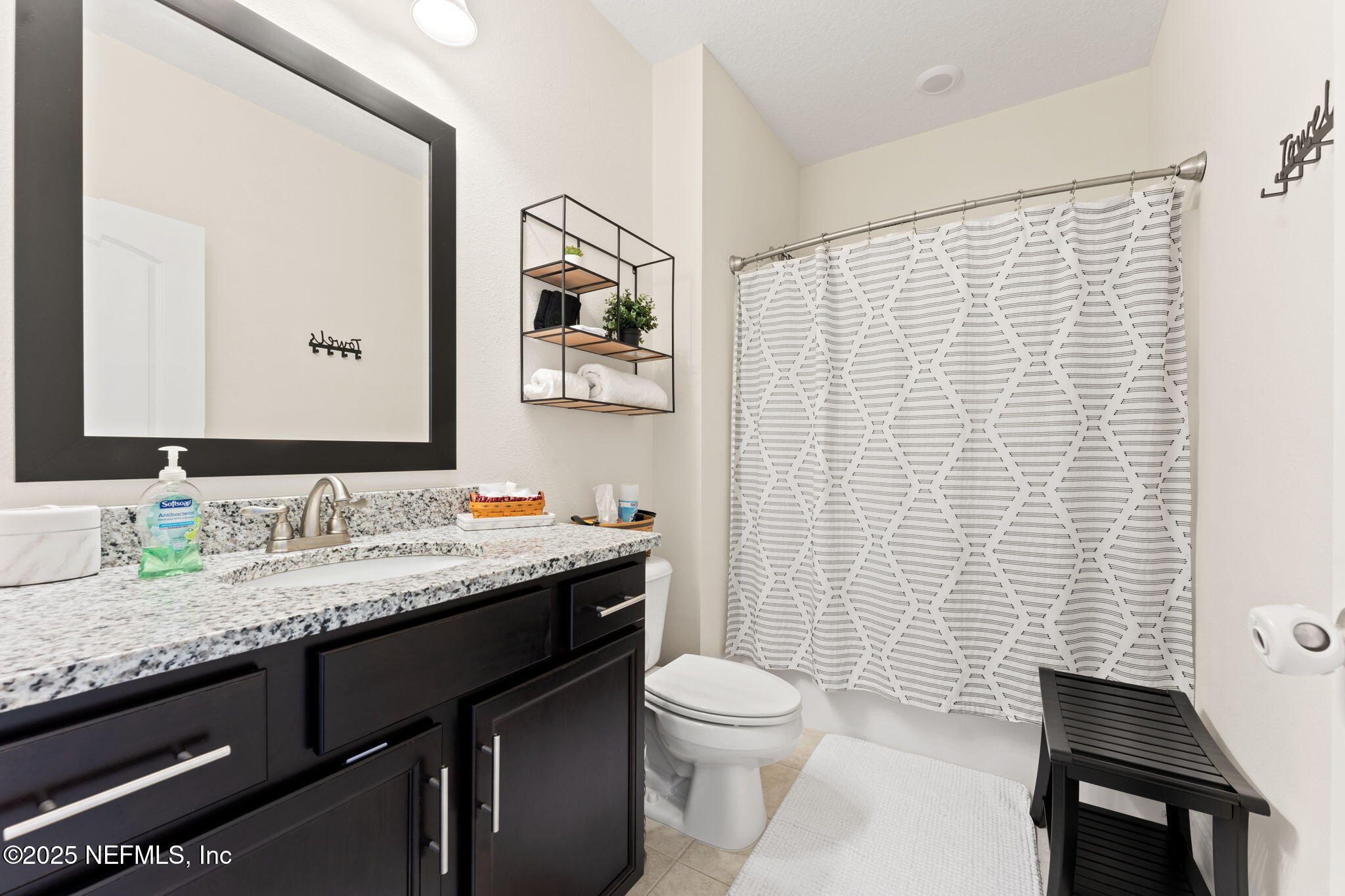 12869 Boney Road Jacksonville, FL 32226 - Photo 41 of 62 a bathroom with a granite countertop sink toilet and mirror