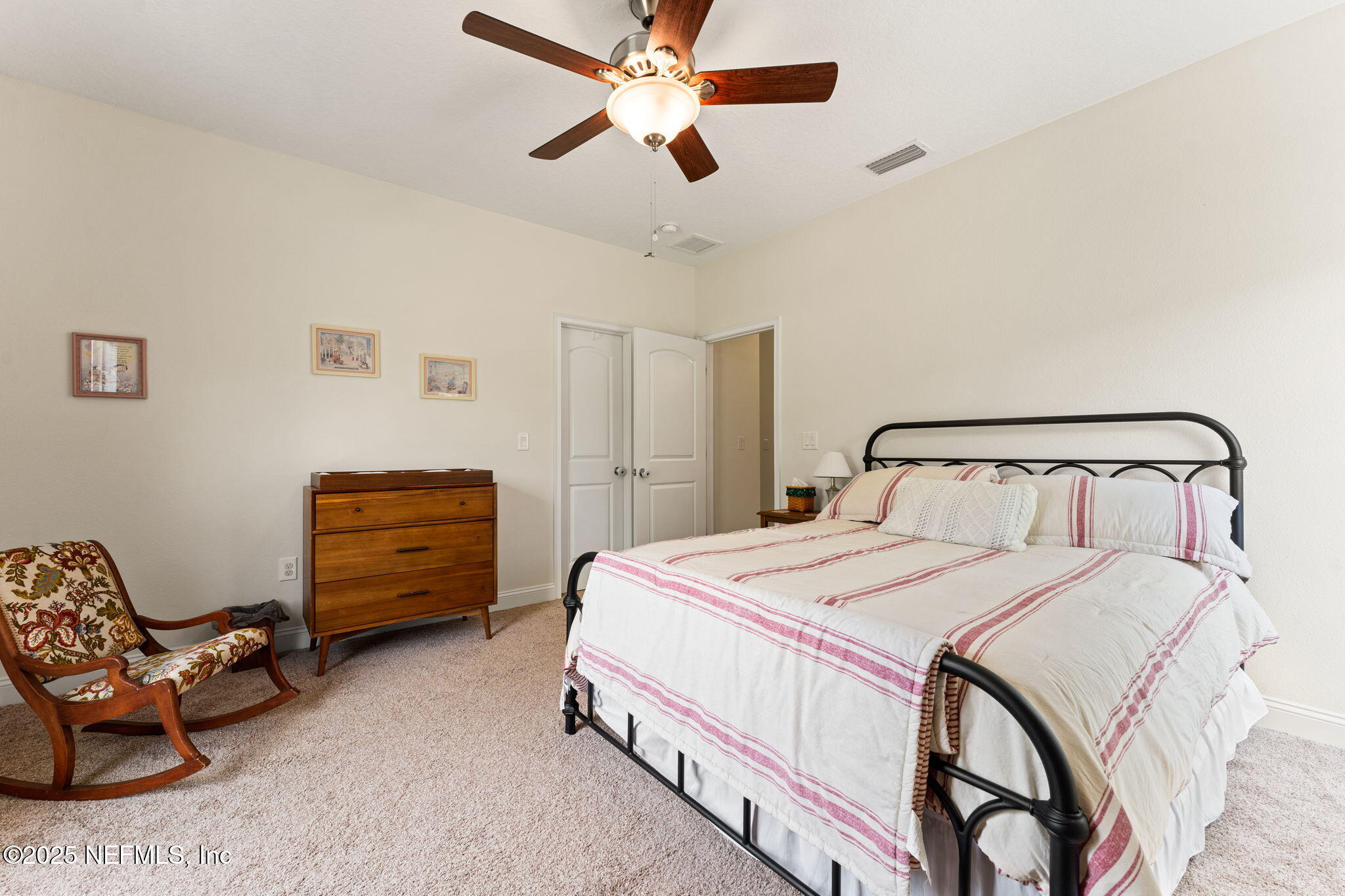 12869 Boney Road Jacksonville, FL 32226 - Photo 42 of 62 a bedroom with a bed and a chandelier