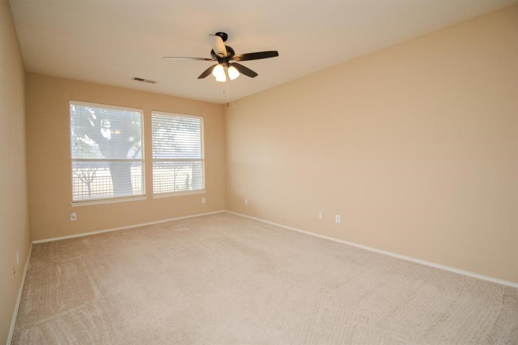 1100 Inland Lane McKinney, TX 75072 - Photo 17 of 36 an empty room with windows and fan