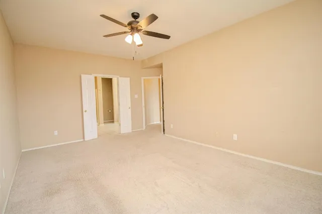 a view of an empty room with a fan