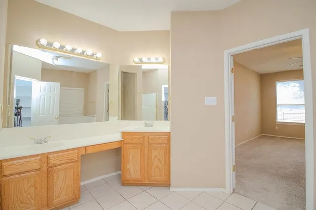a spacious bathroom with a sink a mirror and a bathtub