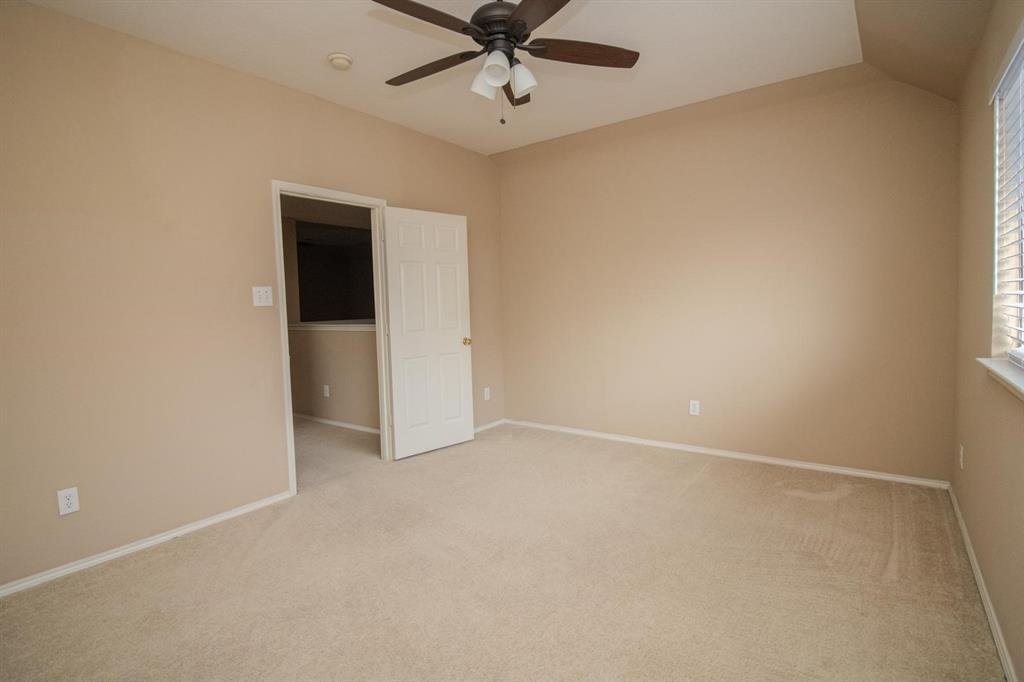 1100 Inland Lane McKinney, TX 75072 - Photo 26 of 36 an empty room with a ceiling fan and carpet