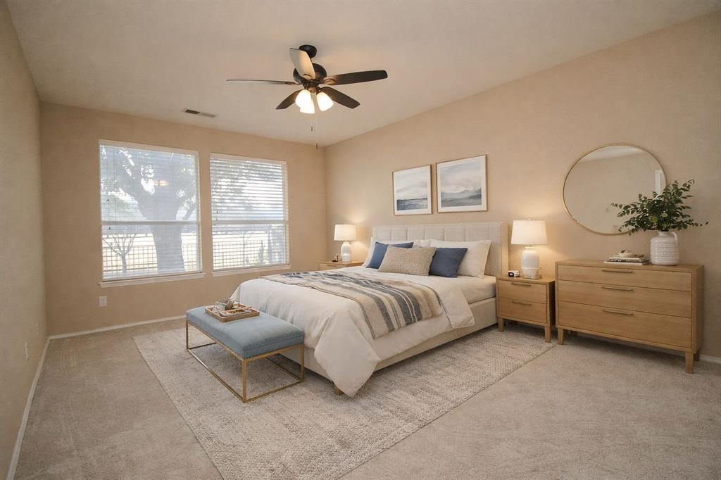 1100 Inland Lane McKinney, TX 75072 - Photo 32 of 36 a spacious bedroom with a bed and a chandelier
