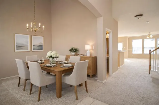 a view of a dining room with furniture and chandelier