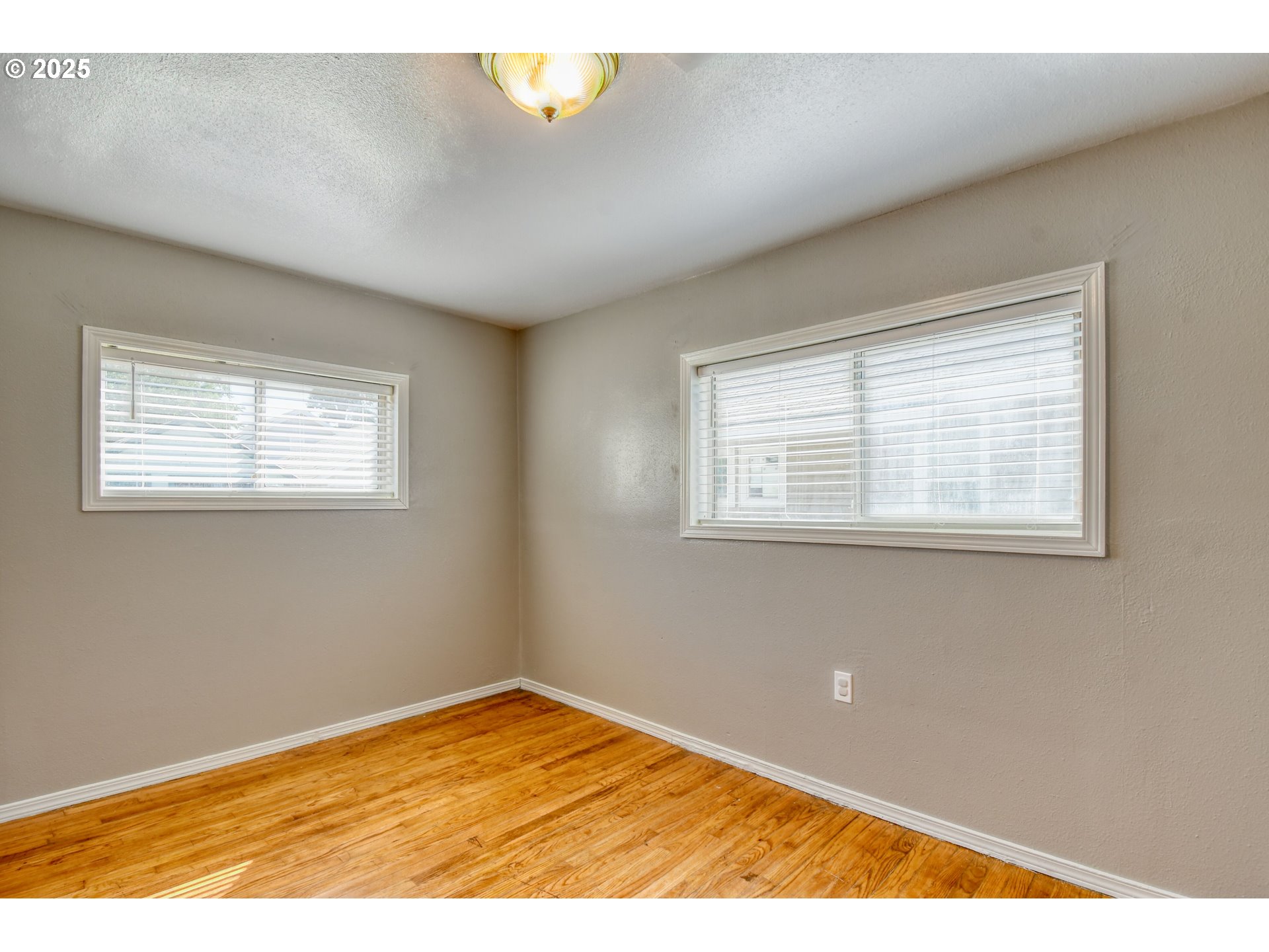 304 Southwest 16th Street Pendleton, OR 97801 - Photo 18 of 34 a view of an empty room with wooden floor and a window