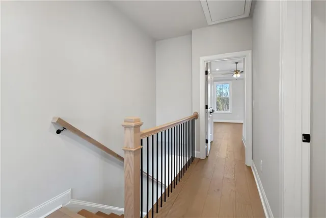a view of a hallway with wooden floor