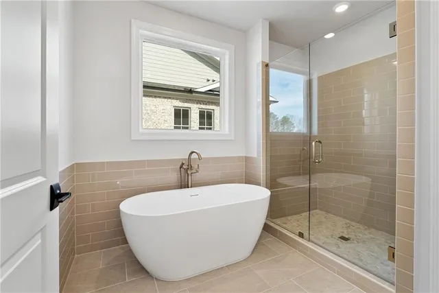 a bathroom with a bathtub and a shower