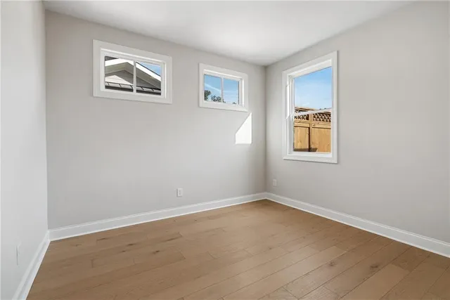 an empty room with windows and closet