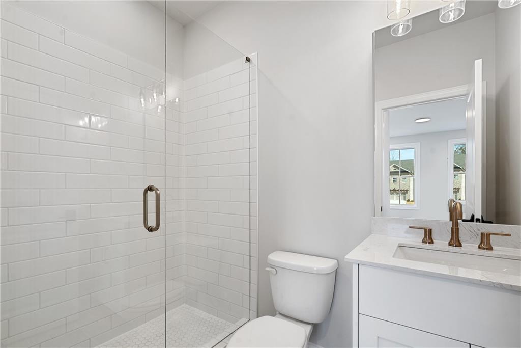 506 Whatton Road, Unit 3 Johns Creek, GA 30022 - Photo 26 of 36 a bathroom with a toilet sink vanity and shower