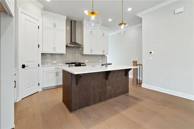 a kitchen with stainless steel appliances a sink stove and cabinets