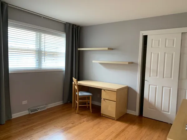 a room with a bunk bed and wooden floor