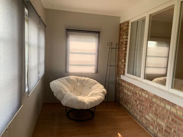 a view of a room that has a rug and a window