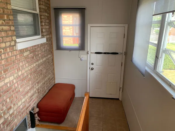 a view of a door and chair in a room
