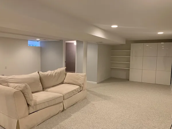 a living room with furniture and a ceiling fan