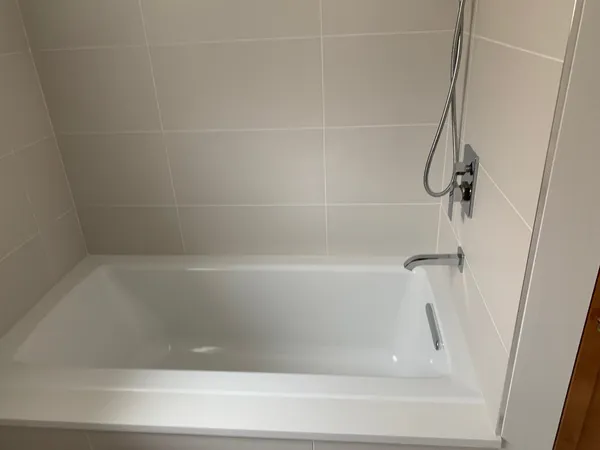 a close up view of bathtub in shower