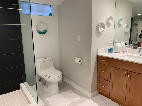 a bathroom with a toilet sink and shower