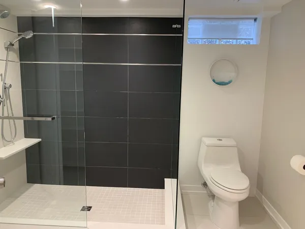a bathroom with a toilet and a shower