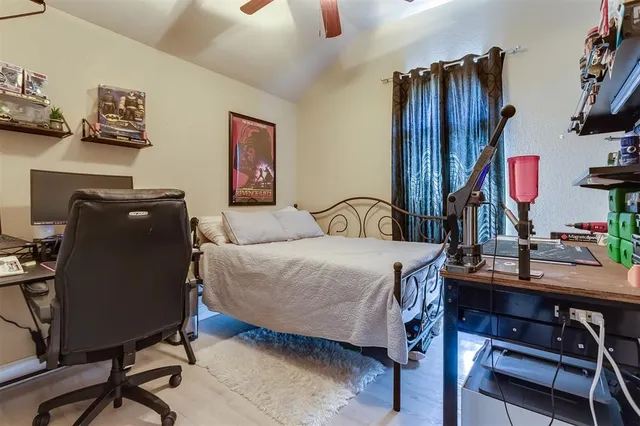 a bedroom with a bed and a desk