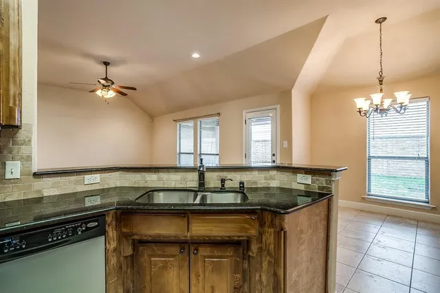 a kitchen with a sink cabinets and a window
