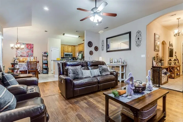 a living room with furniture and a chandelier