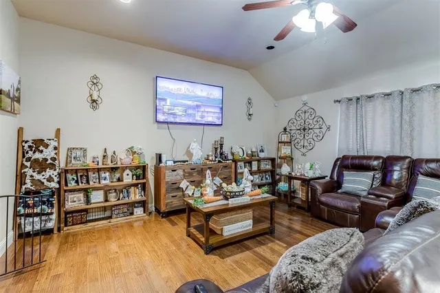 a living room with furniture a rug and a chandelier