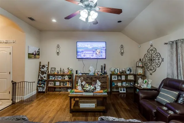 a living room with lots of furniture and wooden floor