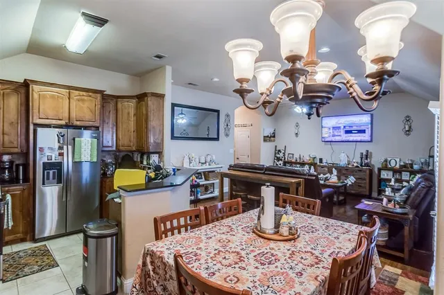 a kitchen with a dining table and chairs