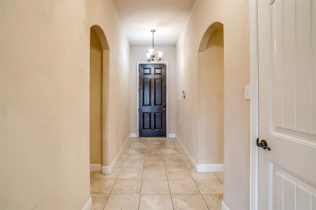 a view of a hallway with entryway wooden floor and front door