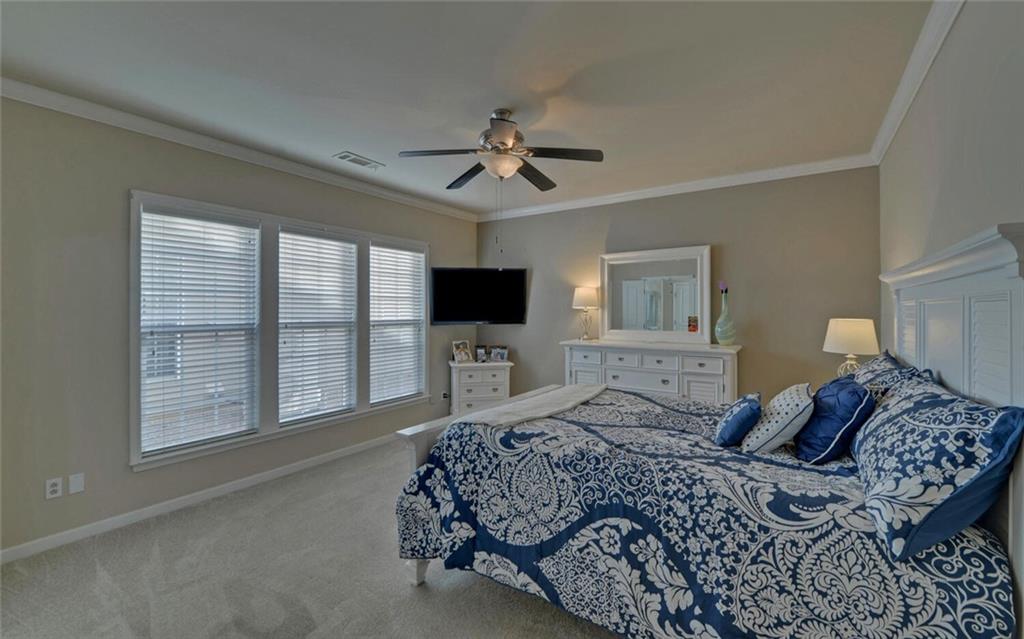 6213 Azalea Way Hoschton, GA 30548 - Photo 18 of 56 a bedroom with a large bed and a flat screen tv