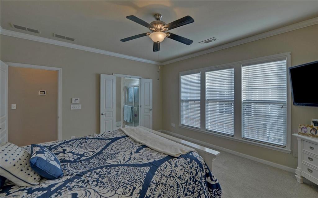 6213 Azalea Way Hoschton, GA 30548 - Photo 19 of 56 a bedroom with a large bed and a large window