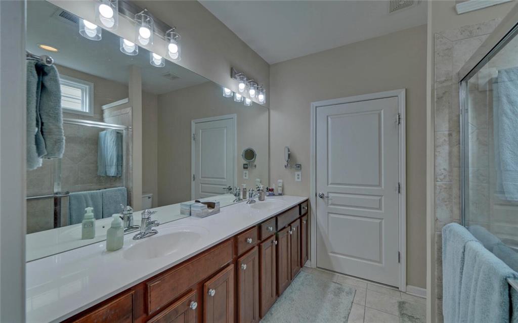 6213 Azalea Way Hoschton, GA 30548 - Photo 22 of 56 a bathroom with a sink double vanity and a mirror
