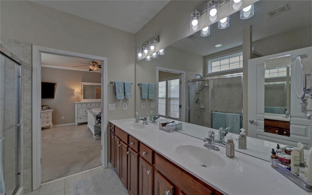 6213 Azalea Way Hoschton, GA 30548 - Photo 24 of 56 a bathroom with double vanity and a mirror