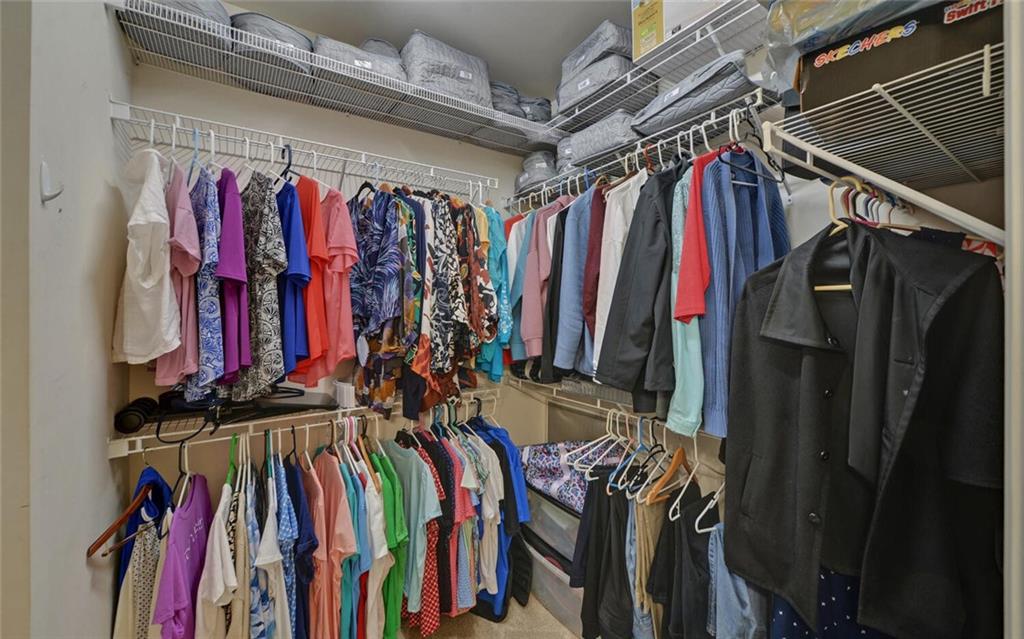 6213 Azalea Way Hoschton, GA 30548 - Photo 25 of 56 a view of walk in closet with clothes