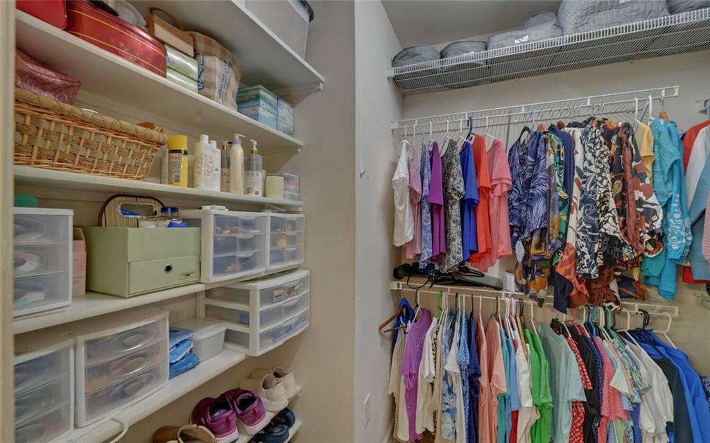 6213 Azalea Way Hoschton, GA 30548 - Photo 26 of 56 a view of walk in closet with clothes and shoes