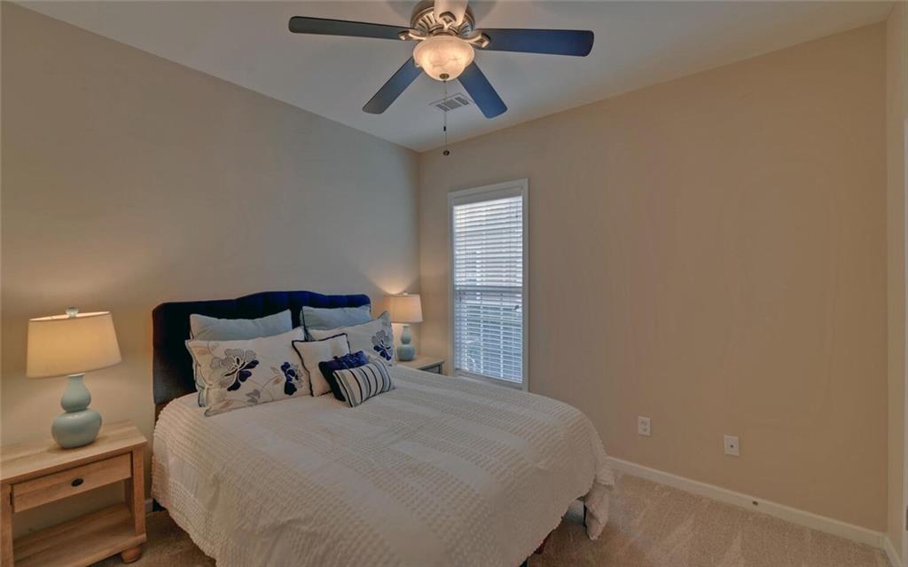 6213 Azalea Way Hoschton, GA 30548 - Photo 29 of 56 a bed sitting in a bedroom next to a window