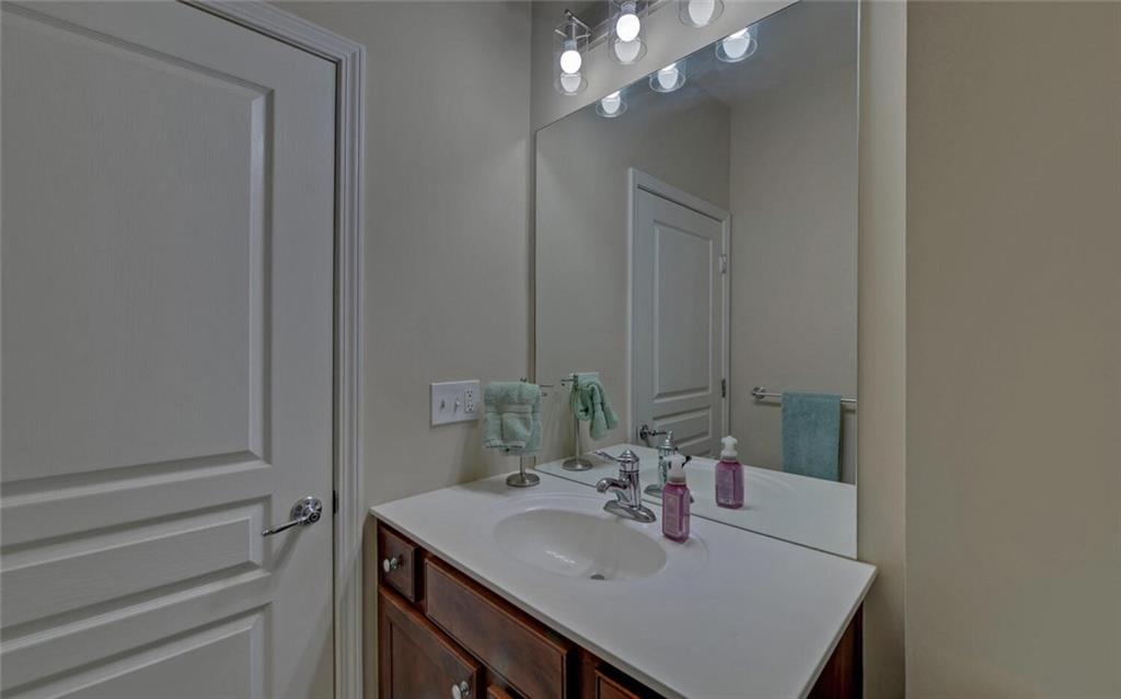 6213 Azalea Way Hoschton, GA 30548 - Photo 32 of 56 a bathroom with a sink vanity and a mirror