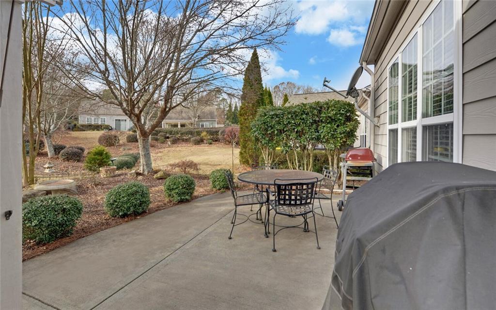 6213 Azalea Way Hoschton, GA 30548 - Photo 35 of 56 a view of a patio with a table and chairs next to a yard