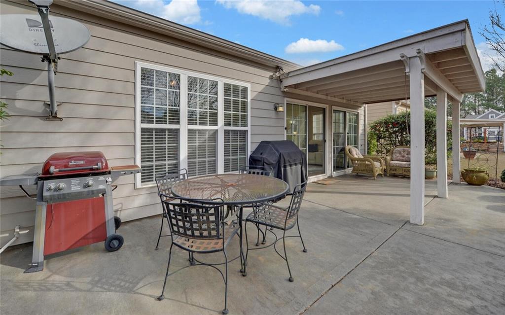 6213 Azalea Way Hoschton, GA 30548 - Photo 36 of 56 a backyard of a house with table and chairs