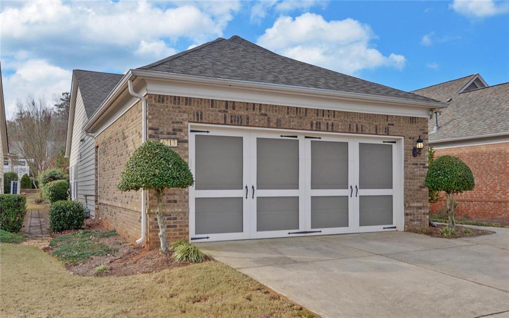 6213 Azalea Way Hoschton, GA 30548 - Photo 42 of 56 a front view of a house with a yard and garage